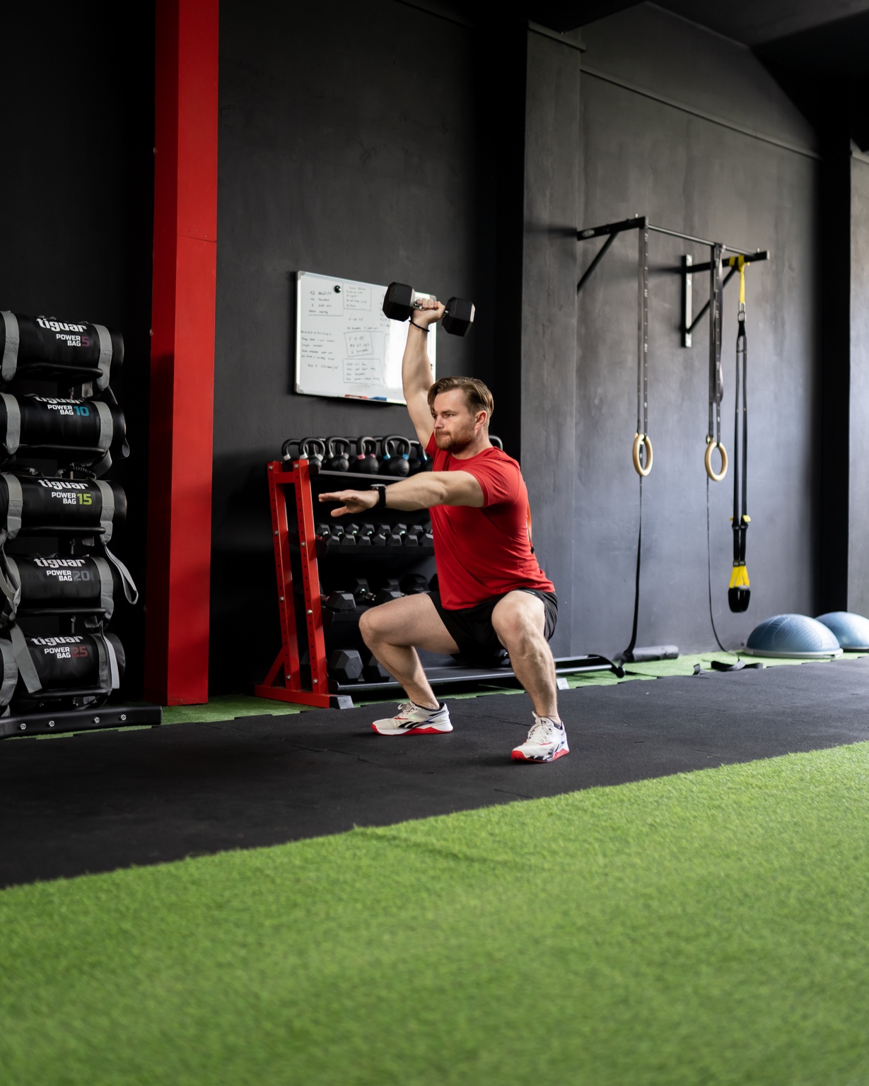 Athlete performing a dumbbell overhead squat at Movement Lab