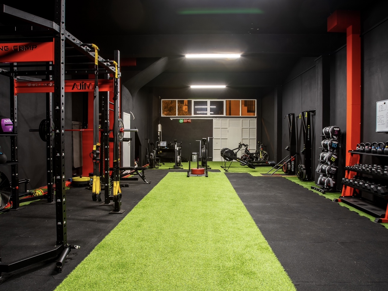 Wide view of the Movement Lab turf lane between racks and conditioning equipment